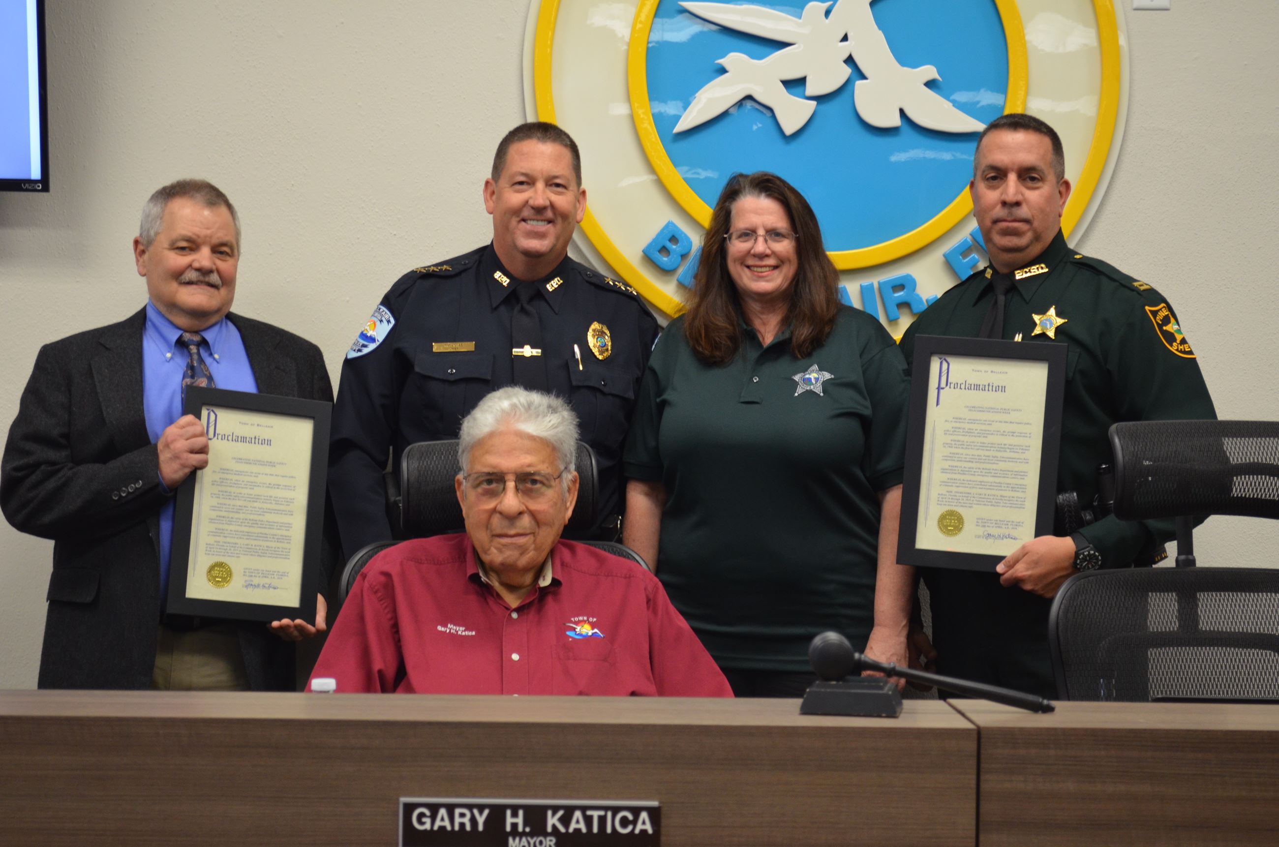 Photo of representatives from 911 call centers, Belleair's Chief of Police, and Belleair's May