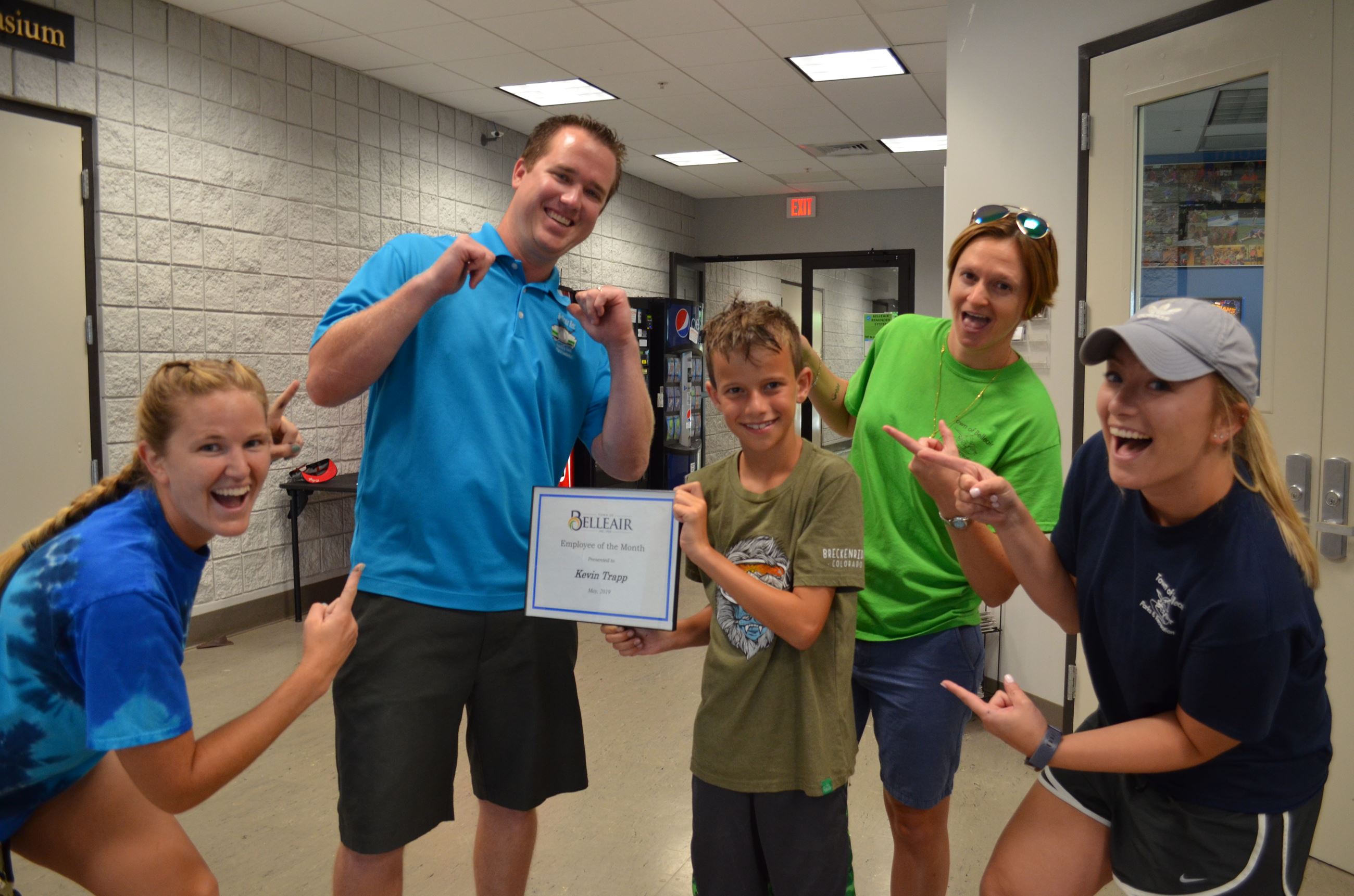 Kevin from the Recreation Department poses with a group with his May, 2019 Employee of the Month cer