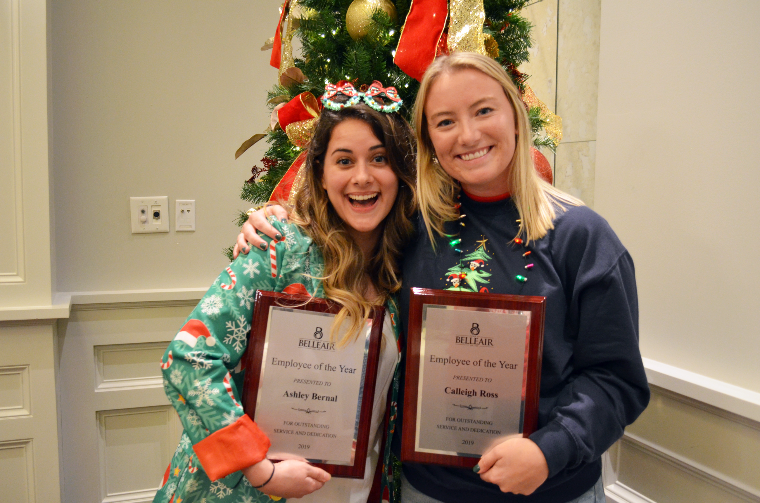 Ashley (left) and Calleigh (right) pose with their matching employee of the year plaques at the Bell