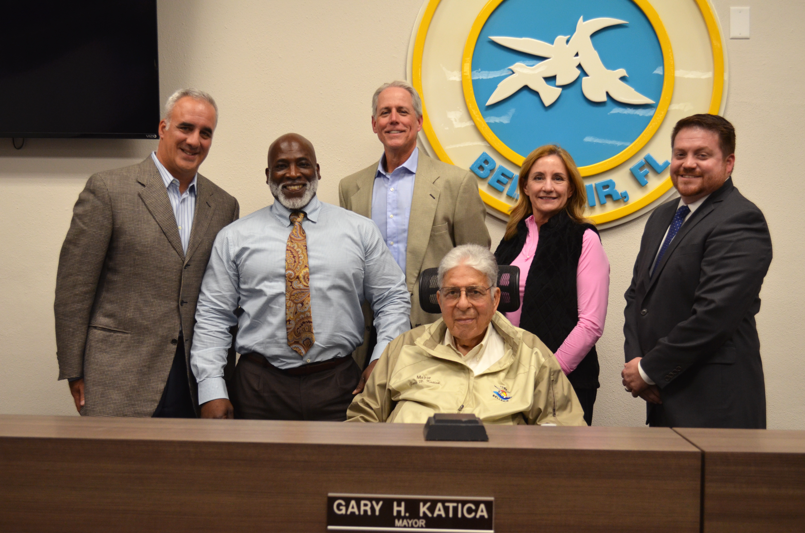 Newly-appointed Director of Solid Waste, Wilfred Holmes, stands and smiles with the Town Commission 
