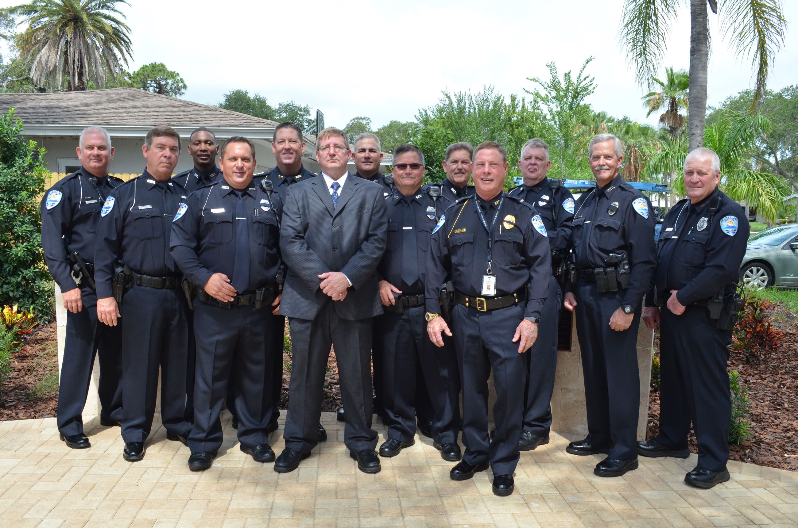 The uniformed officers of the Belleair Police Department pose in Jeffery W. Tackett Park at its gran