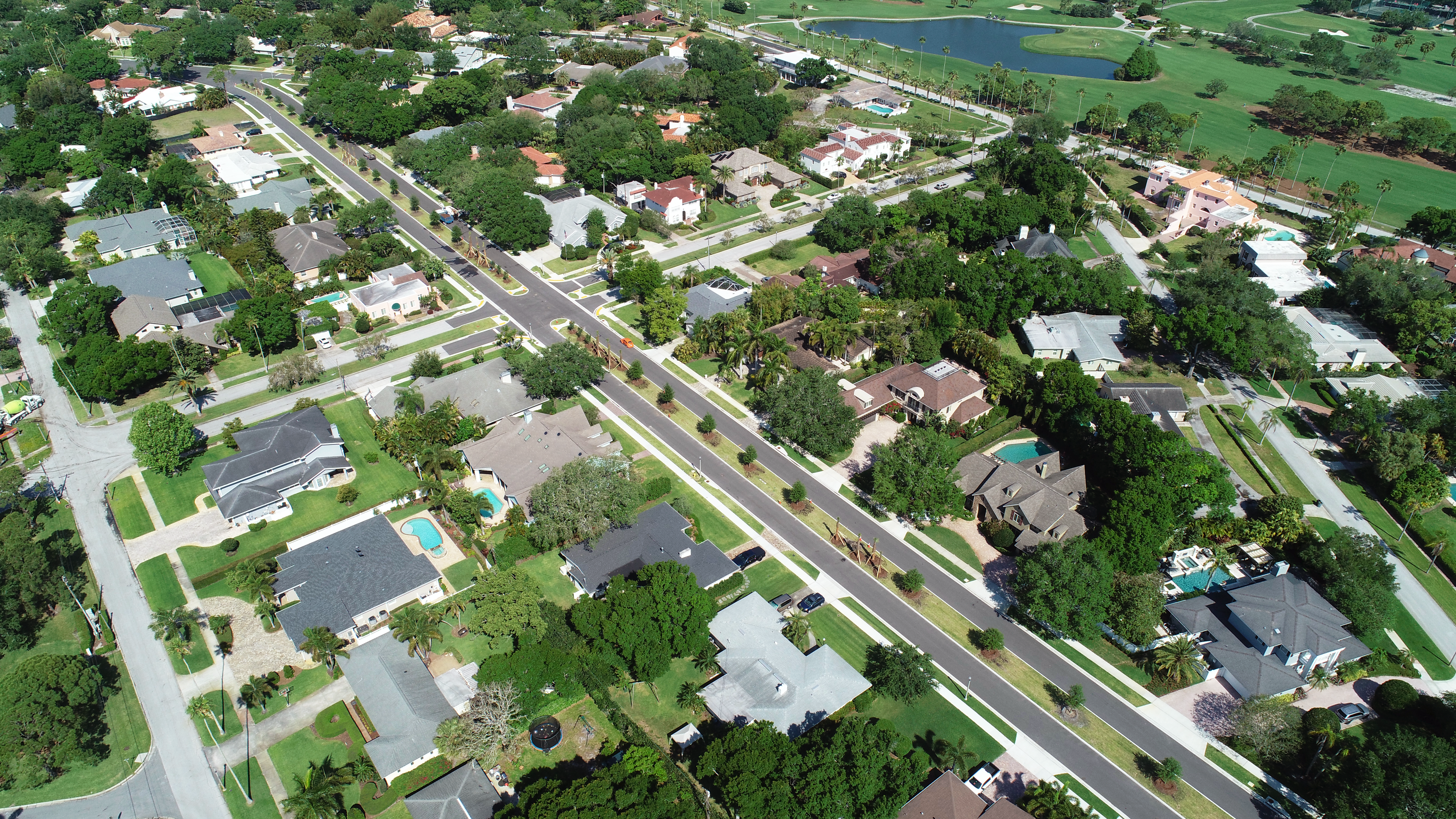 An aerial view of the completed project with homes and a golf course in the background