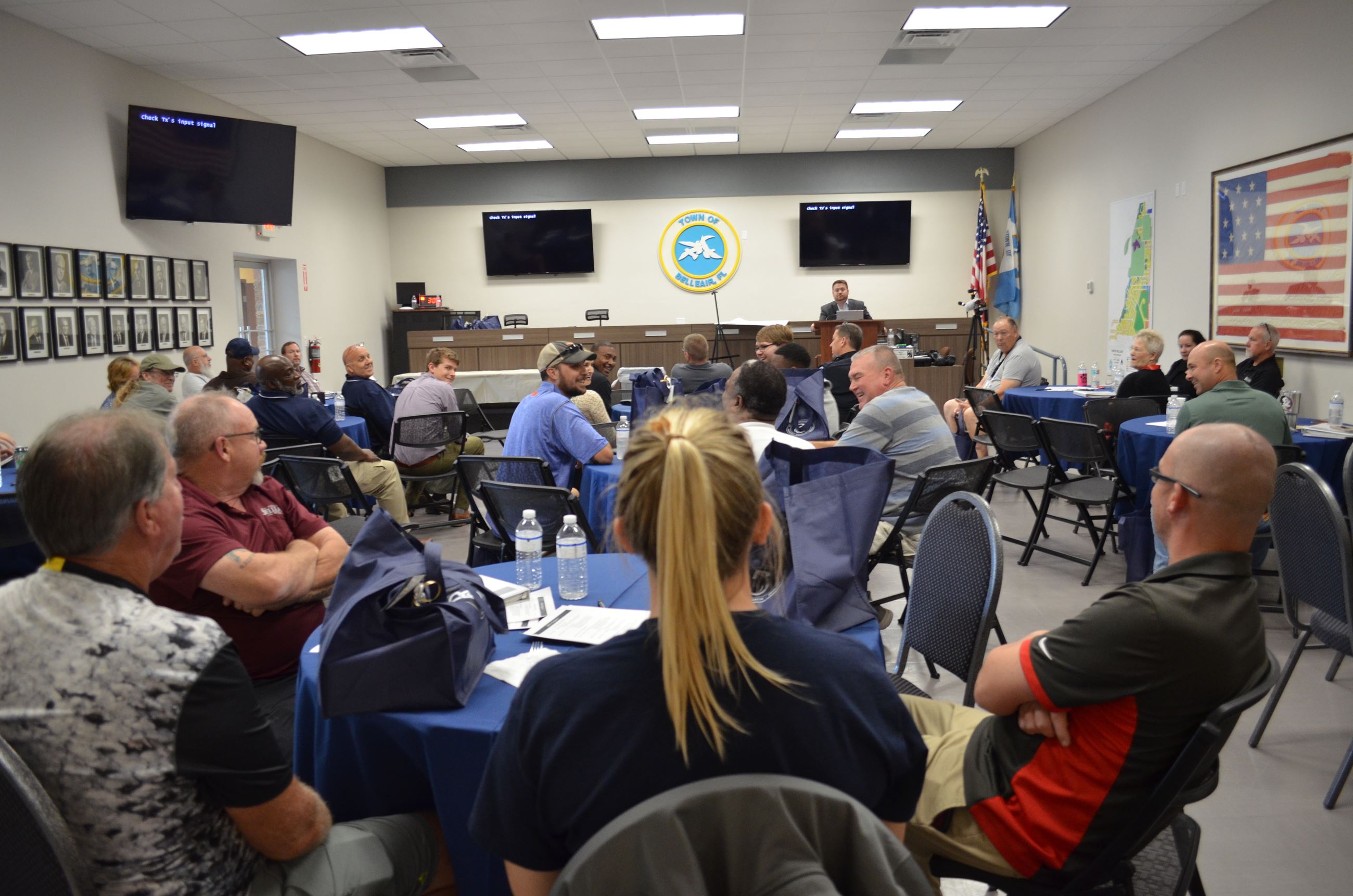 A large group of Belleair employees listen to a presentation in the Town Hall Auditorium.