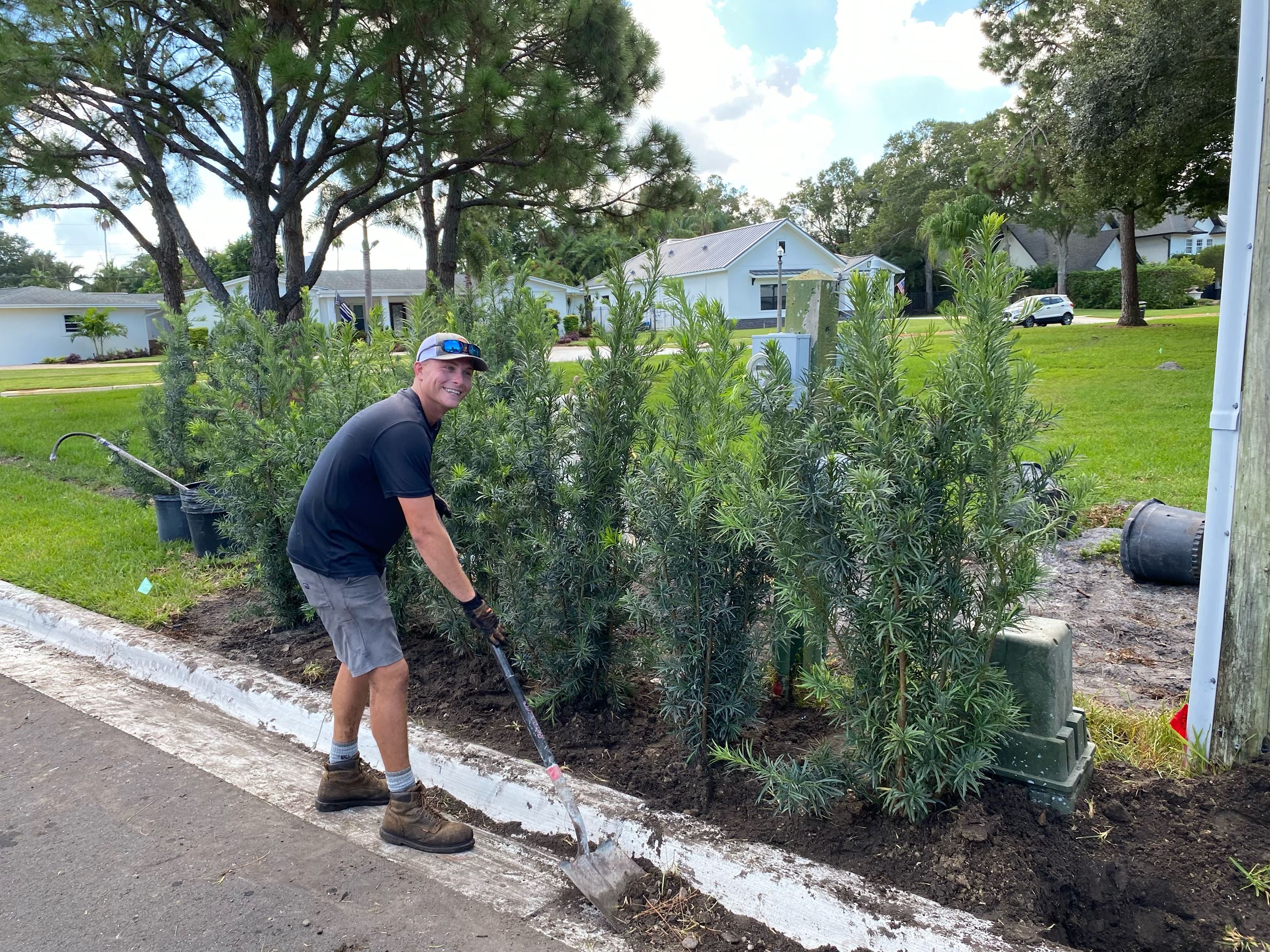 A public works employee smiles while shoveling some dirt in Pinellas Park. 